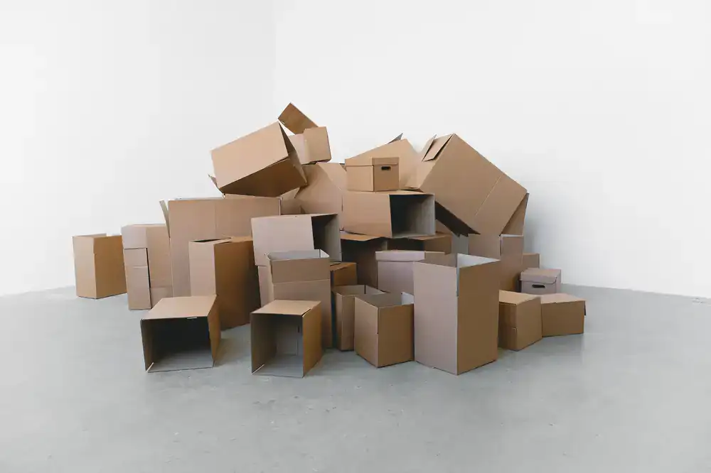 Stacks of flat-packed cardboard boxes in a clean warehouse environment