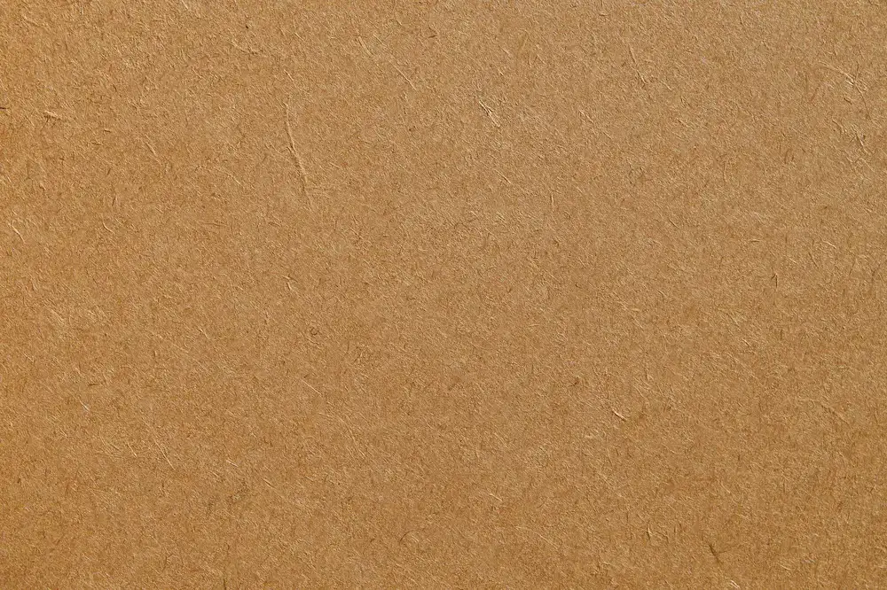 Close up of a sustainable packaging printing press applying water-based ink to kraft cardboard