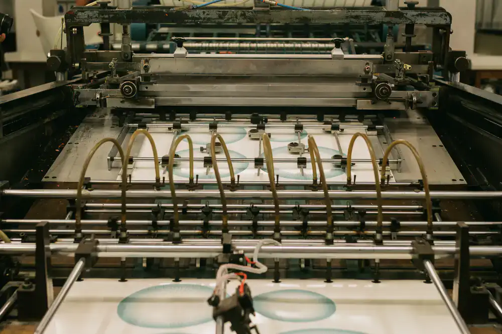 Detailed view of a modern packaging printing press applying water-based ink